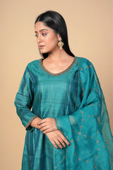 A women wearing peacock green pure tussar salwar suit, party wear for women