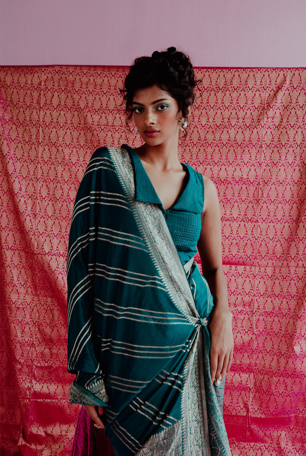 A woman wearing peacock blue pure crepe saree, latest saree, new saree collection