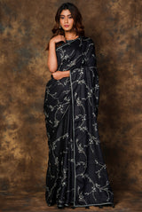 A woman wearing black pure tussar embroidered saree, latest saree, new saree collection
