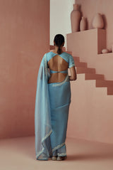 A women wearing light blue pure organza saree, party wear for women.