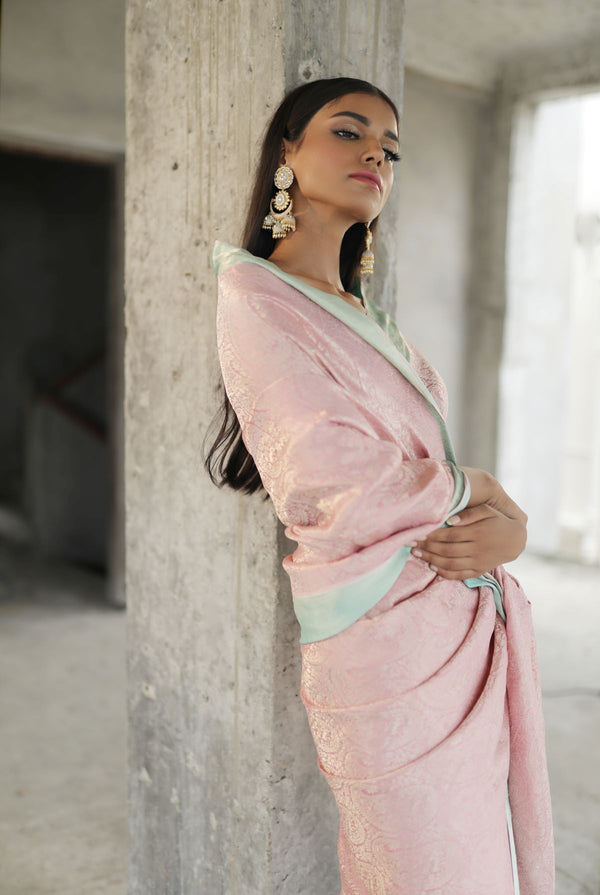A woman wearing pure crepe pastel pink saree, latest saree, new saree collection
