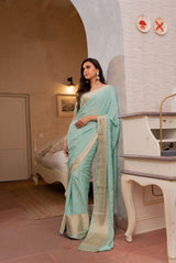 A woman wearing pure crepe pastel blue saree, latest saree, new saree collection