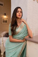 A woman wearing pure crepe pastel blue saree, latest saree, new saree collection