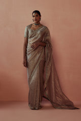 A women wearing pure tissue saree with crinkled texture, party wear for women.