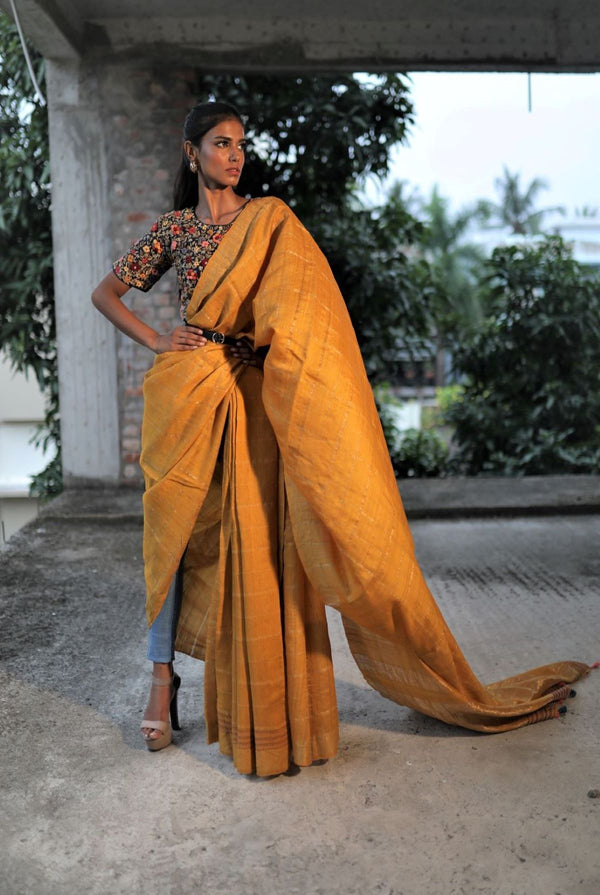 A woman wearing mustard pure tussar saree, latest saree, new saree collection