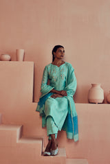 A women wearing pure fancy chanderi firoza suit set with organza dupatta, ethnic wear for women.