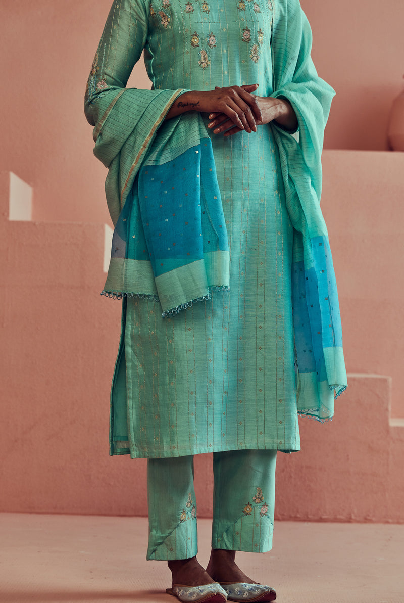A women wearing pure fancy chanderi firoza suit set with organza dupatta, ethnic wear for women.