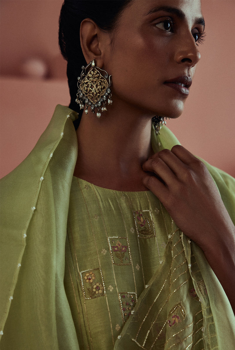 A women wearing pastel green fancy chanderi suit set with organza dupatta, ethnic wear for women.