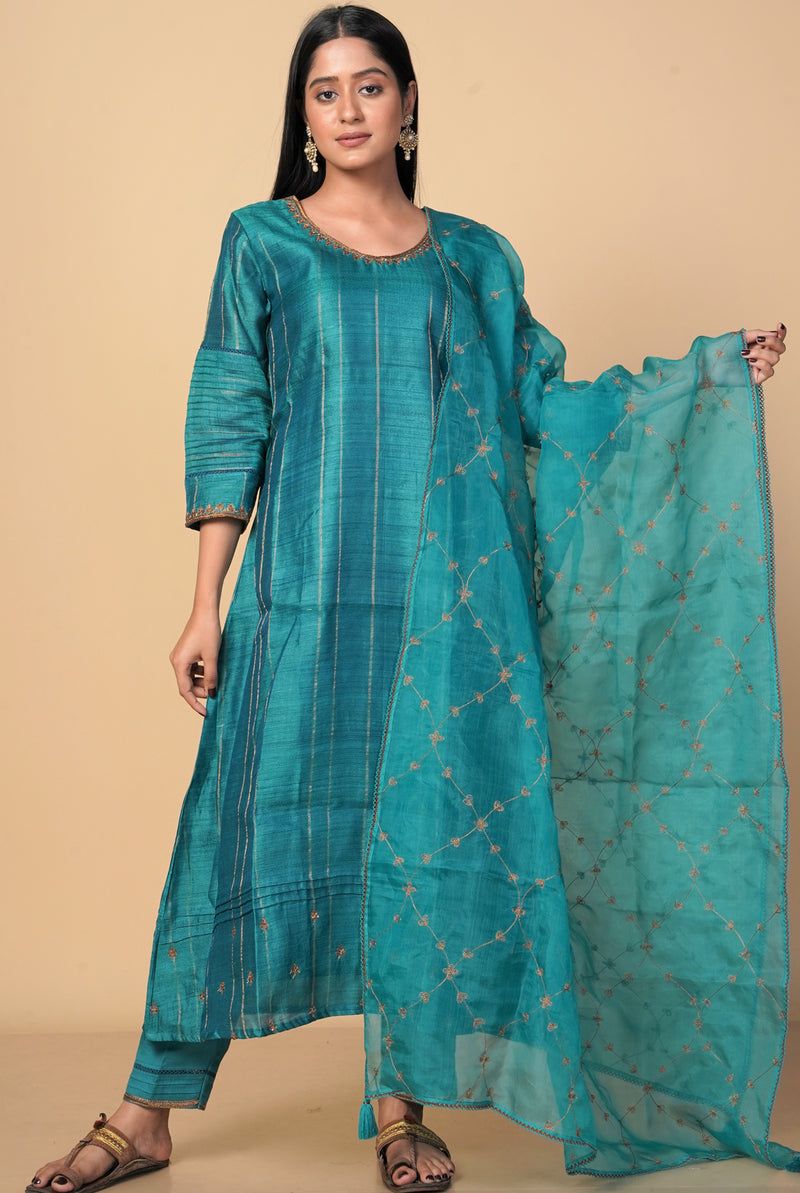 A women wearing peacock green pure tussar salwar suit, party wear for women