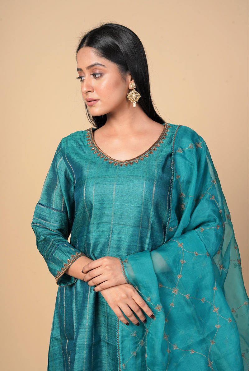 A women wearing peacock green pure tussar salwar suit, party wear for women