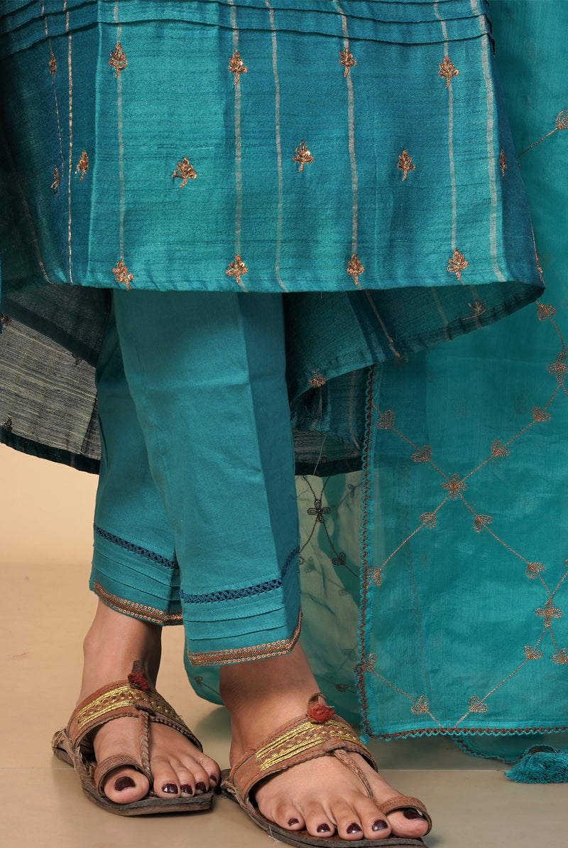 A women wearing peacock green pure tussar salwar suit, party wear for women