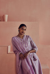 A women wearing pure fancy chanderi lilac angrakha style suit set, party wear for women.