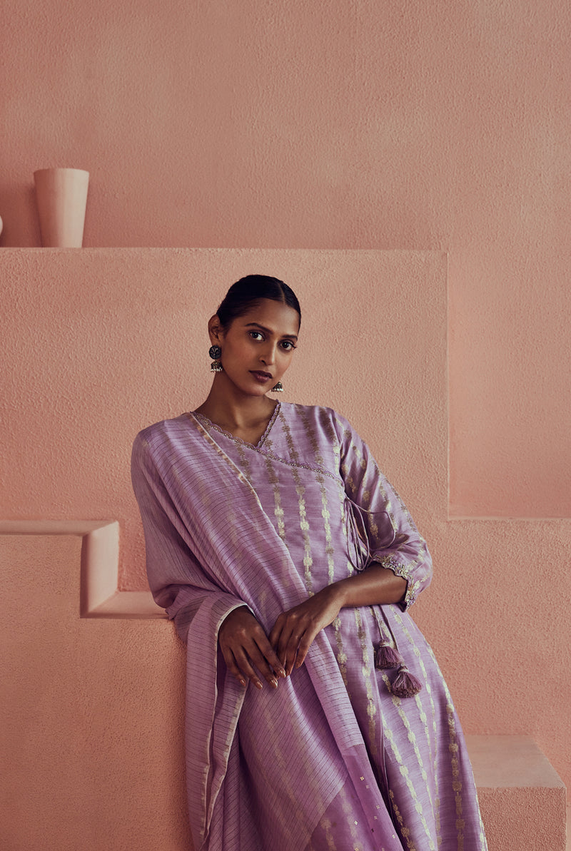 A women wearing pure fancy chanderi lilac angrakha style suit set, party wear for women.