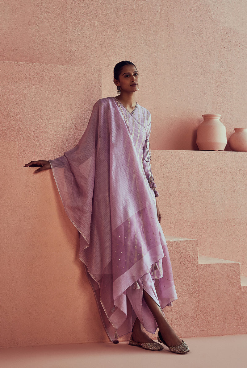A women wearing pure fancy chanderi lilac angrakha style suit set, party wear for women.