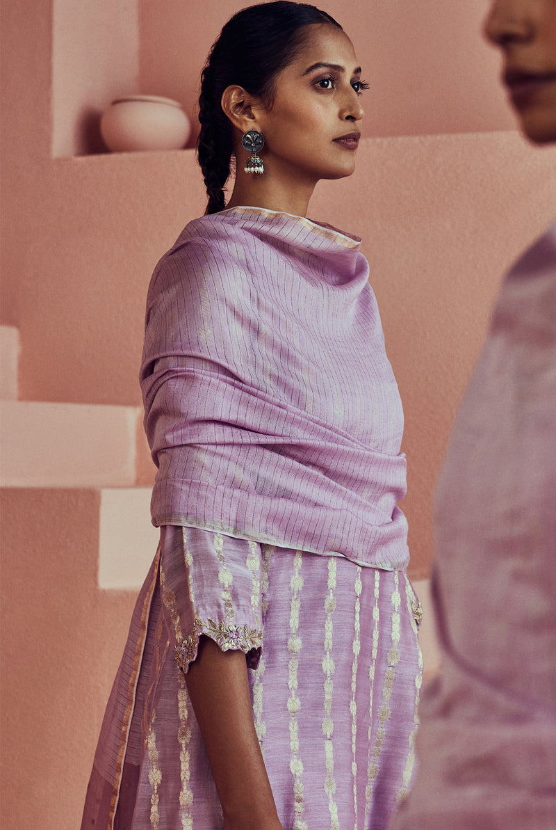 A women wearing pure fancy chanderi lilac angrakha style suit set, party wear for women.