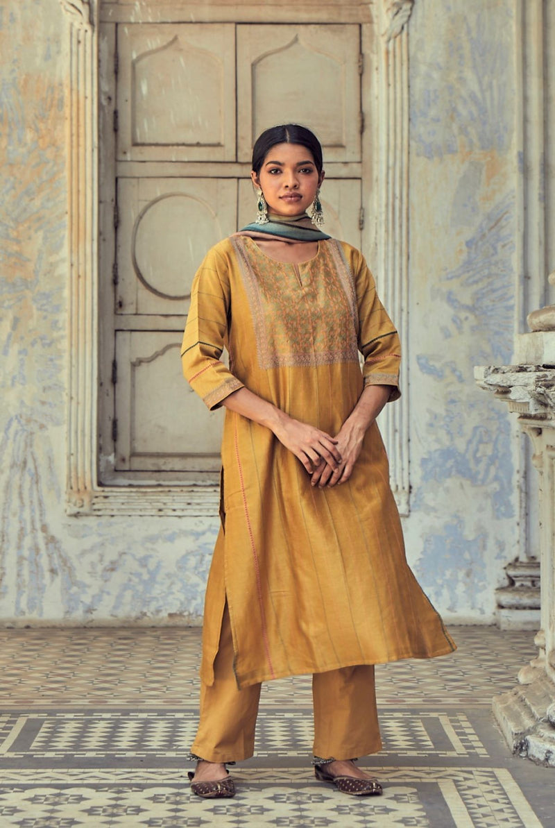 A women wearing mustard party wear salwar suit, ethnic wear for women.