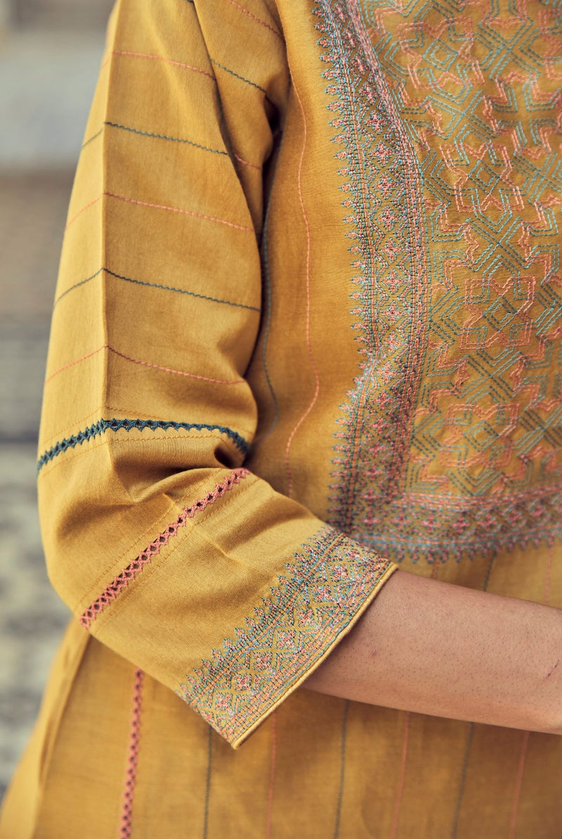 A women wearing mustard party wear salwar suit, ethnic wear for women.