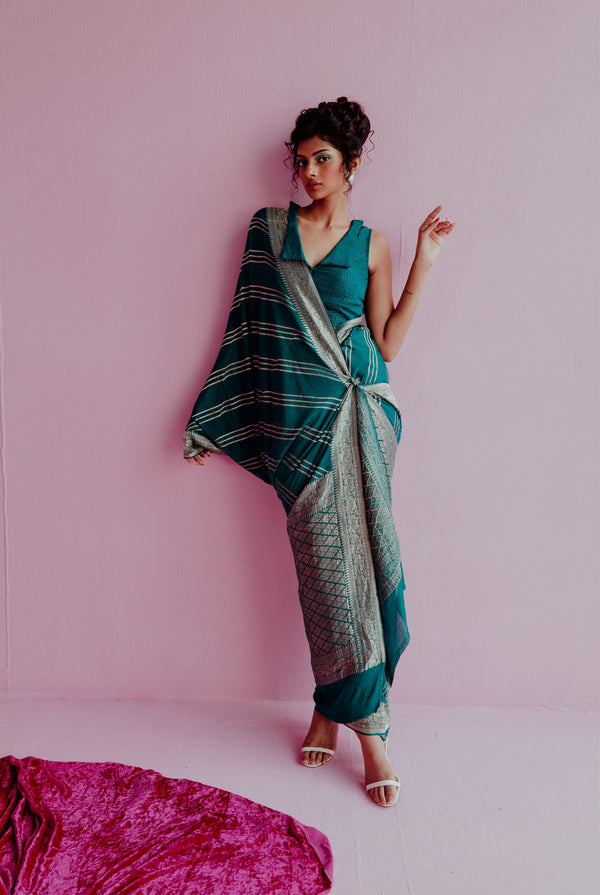 A woman wearing peacock blue pure crepe saree, latest saree, new saree collection