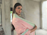 A woman wearing pure crepe pastel pink saree, latest saree, new saree collection