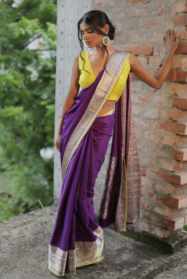A woman wearing purple pure crepe saree, latest saree, new saree collection