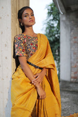 A woman wearing mustard pure tussar saree, latest saree, new saree collection