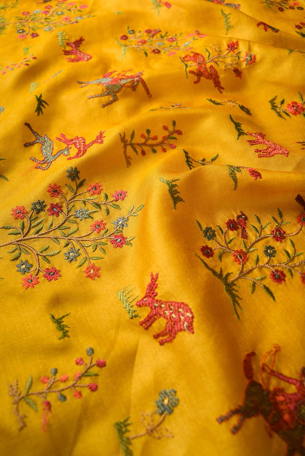 A woman wearing mustard tussar resham embroidered saree, latest saree, new saree collection