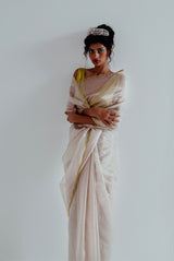 A woman wearing silver pure tissue saree, latest saree, new saree collection