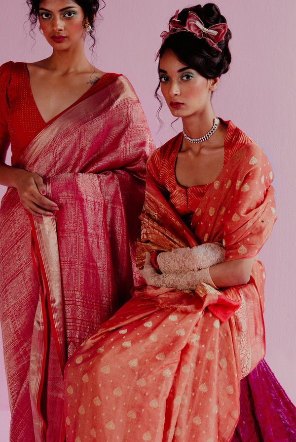 A woman wearing orange pure tissue georgette saree, latest saree, new saree collection