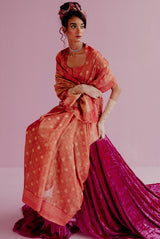 A woman wearing orange pure tissue georgette saree, latest saree, new saree collection