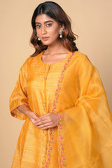 A women wearing mustard pure tussar party wear salwar suit, ethnic wear for women