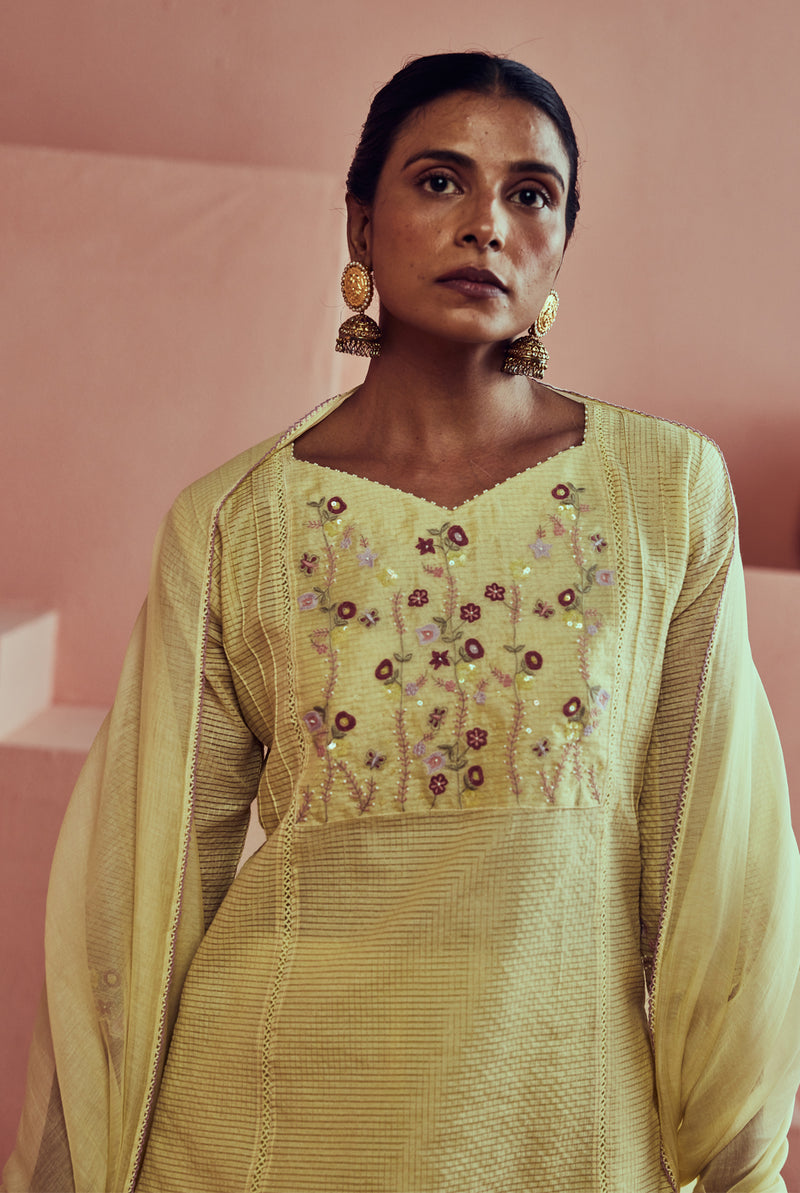 A women wearing yellow pure fancy chanderi suit set, ethnic wear for women.